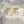 Gold earrings with cross design on a textured white surface