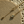 Gold necklace with a star-shaped pendant on a textured surface