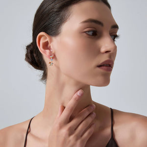Woman wearing earrings with a neutral background