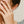 Close-up of a hand wearing a ring with a blurred background
