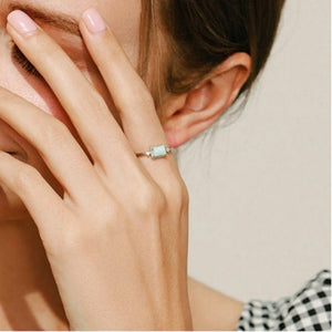 Close-up of a hand wearing a ring with a blurred background