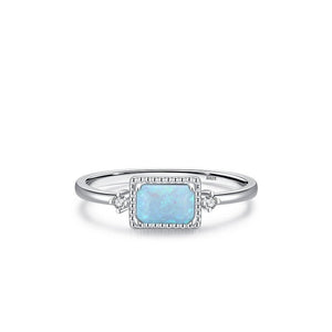 Silver ring with a square blue stone on a white background
