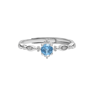Silver ring with a blue gemstone on a white background