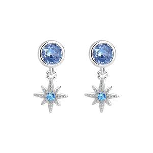 Silver earrings with blue gemstones on a white background