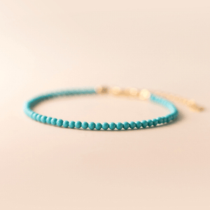 Turquoise beaded bracelet on a beige background