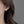 Earring worn by a person with a neutral background
