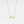Gold necklace with butterfly pendant on a light gray background