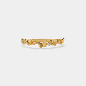 Gold ring with butterfly designs on a white background