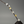 Decorative branch with gold and silver floral elements on a gray background