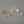 Gold and silver flower-shaped earrings on a gray background