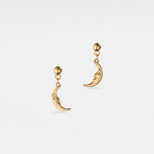 Gold moon-shaped earrings on a light gray background