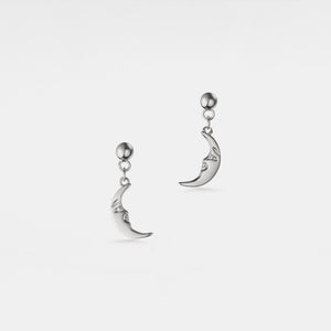 Silver moon-shaped earrings on a white background