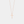 Rose gold cross necklace on a light gray background