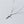 Silver cross necklace on a light gray background