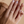 Gold ring on a hand with a neutral background