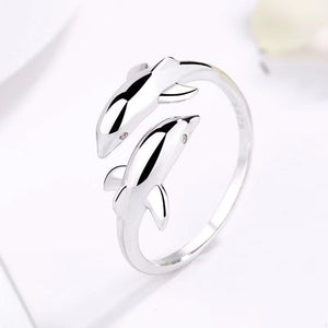 Silver dolphin-shaped ring on a white background