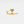 Gold heart-shaped ring on a light gray background