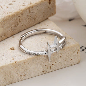Silver ring with star-like design on a stone