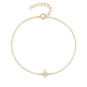 Gold bracelet with a star-shaped charm on a white background