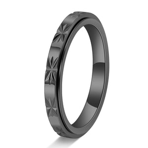 Three custom 3mm fidget spinner rings placed side by side on a textured surface. The rings appear to be made of titanium steel with hypoallergenic gold plating in rose gold, yellow gold, and silver colors.