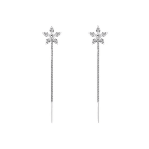 Pair of silver floral earrings on thin chains against a white background