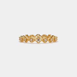 Gold ring with diamond accents on a white background