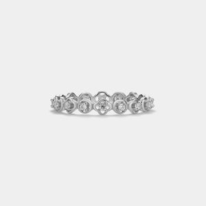 Silver ring with diamonds on a light gray background