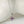 Silver necklace with a purple flower-shaped pendant on a white background