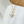 Gold necklace with a diamond pendant on a white surface