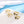Set of gold rings with gemstones on a light blue background