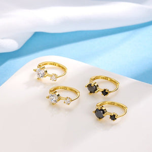 Set of gold rings with gemstones on a light blue background