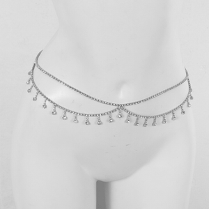 Silver necklace with dangling beads on a mannequin head against a white background