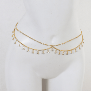 Gold necklace with small beads on a mannequin head against a white background