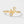 Gold ring with diamond accents on a light gray background