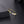 Gold open ring with small diamonds on a dark surface