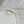Gold ring with small diamonds on a light fabric background
