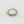 Gold ring with pearls on a light gray background