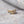 Gold heart-shaped ring on a textured surface