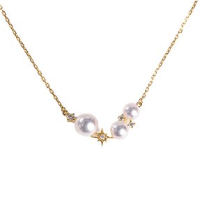 Pearl necklace with gold chain and star-shaped clasps on a white background