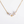 Pearl necklace with gold chain and star-shaped clasps on a white background