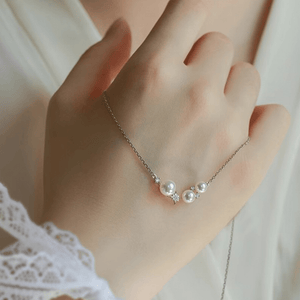 Pearl necklace on a hand with a soft background