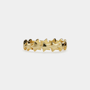 Gold star-shaped ring on a white background