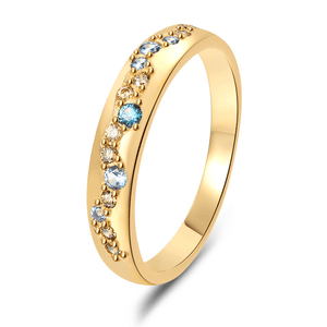 Gold ring with colorful gemstones on a white background
