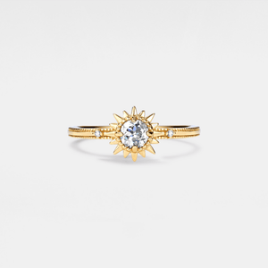 Gold ring with a diamond on a light gray background