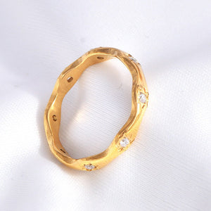 Gold star ring with cubic zirconia accents on a white background