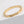 Gold ring with star patterns on a light gray background