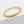 Gold ring with star patterns on a light gray background