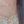 Gold necklace with a delicate pendant worn by a person with light-colored hair.