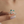 Silver ring with green gemstones on a finger against a blurred background