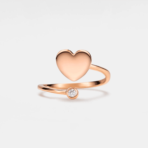 A gold-plated sterling silver ring featuring a heart-shaped design with a small cubic zirconia embellishment on the top.